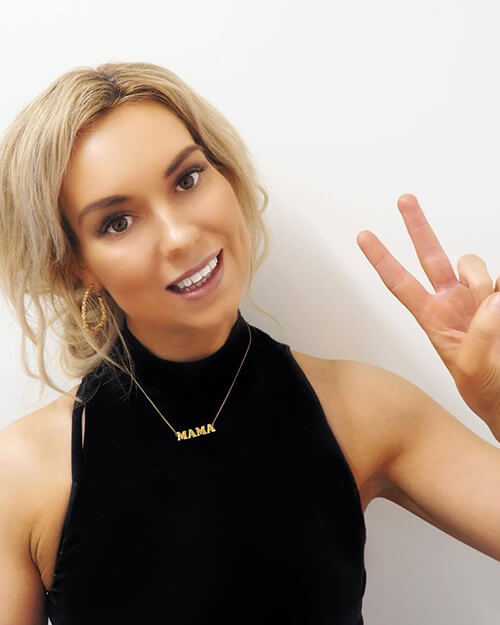 Girl showing peace sign after teeth whitening