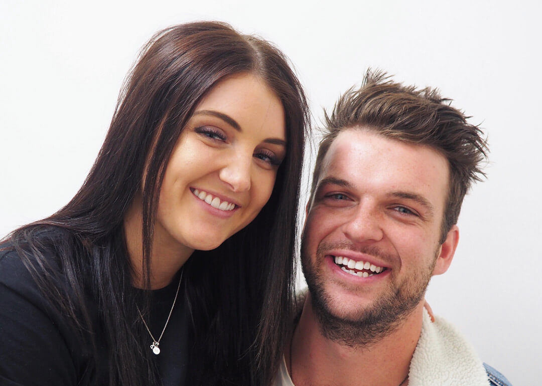 Couple smiling after teeth whitening