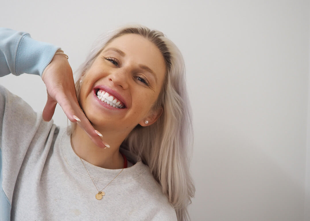 Fun girl smiling to show professional teeth whitening results